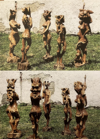 Holzschnitzfiguren weibl.und männl. "PANfiguren"auf grüner Wiese vor erodierender Steinmauer